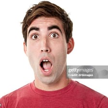 A person reacting with visible shock and an open-mouthed gasp.