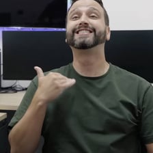 A person raising a hand to signal someone to stop.