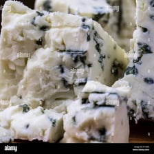 Blue-green mold veins visible in a piece of blue cheese