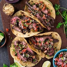 Tacos filled with grilled carne asada.