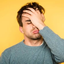 A person complaining with a visibly frustrated expression.