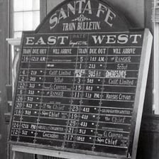A railway arrival board showing a train scheduled to arrive.