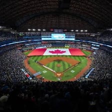 A crowd at Toronto’s Rogers Centre during a Canadian national anthem performance.