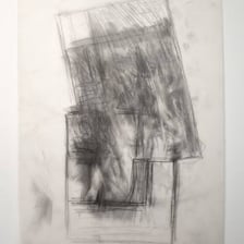 An artist tracing an image through transparent paper