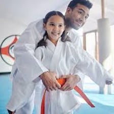 A martial-arts instructor teaching students in a dojo.