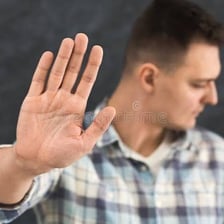 A person gesturing denial with raised hands.