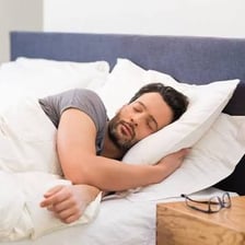A tired person resting and appearing ready for a nap.
