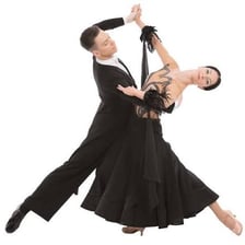 A couple dancing a waltz in formal attire