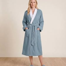 A tranquil spa interior with guests in relaxed robes.
