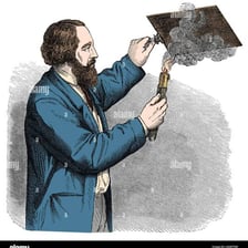An artist creating an etched design on a metal plate