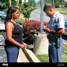 A person discreetly giving information to a police officer.