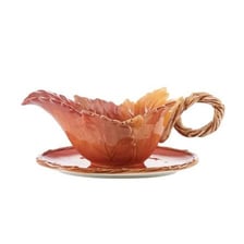 Gravy with visible lumps in a serving boat.