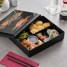 A Japanese bento box containing rice and assorted side dishes