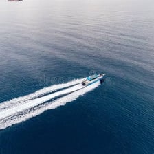 A motorboat creating a visible wake behind it
