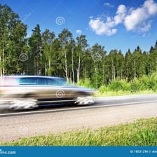 A car traveling quickly on a highway with motion blur