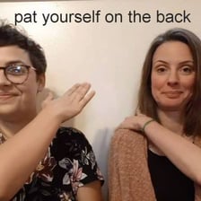 A person reaching back to pat themselves in congratulations