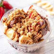 An açai bowl topped with oats and fruit.