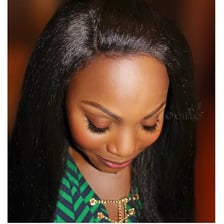 A hairstyle with added hair extensions woven into the natural hair.
