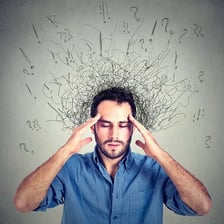 A person looking troubled while dealing with a persistent worry