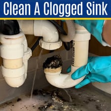 A household sink with water backed up because of a clogged drain
