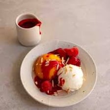 A Peach Melba dessert with peaches, raspberry sauce, and ice cream