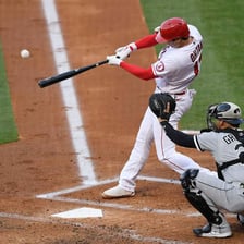 A baseball player hitting a ball during a home run.