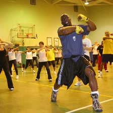 People performing martial-arts-inspired movements in a fitness class