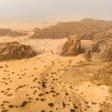 A hot, dry landscape of sand dunes in the Sahara Desert.