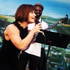 A jazz vocalist performing into a microphone