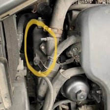 A flexible automotive hose connected to a car radiator