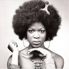 A person using a hair pick to style an afro