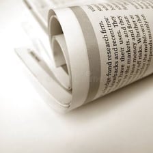 A printed newspaper page featuring a news article