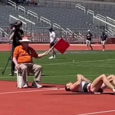 An athlete making an errant throw that misses its target.