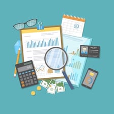 Financial records and a calculator arranged for an audit.