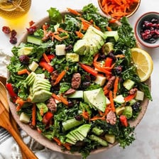 Curly green kale leaves arranged in a salad bowl.