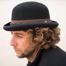 A traditional black bowler hat made of felt