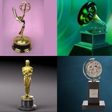 Four entertainment awards representing an Emmy, Grammy, Oscar, and Tony.