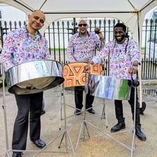 Musicians perform together on Caribbean steel pans.