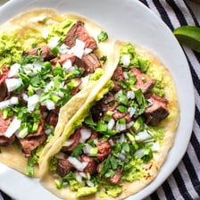 A taco filled with carne asada and toppings.