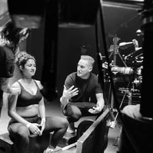 A director giving instructions to performers on a film set.