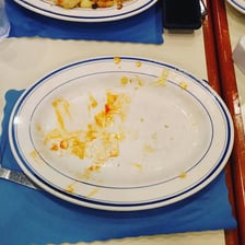 An empty plate after a meal has been eaten