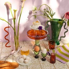 Decorative objects being added to a vase