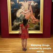 A person gazing intently at a work of art.