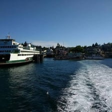 Passenger ferry approaching an island harbor
