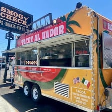 A food truck serving tacos to customers