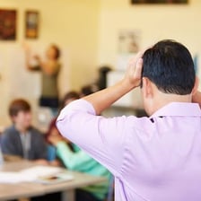 A teacher addressing a student in a reprimanding manner.