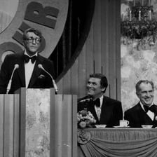 A comedian delivering humorous insults at a roast
