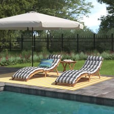A deck chair positioned beside a swimming pool