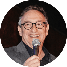 Science journalist Ira Flatow speaks into a microphone.