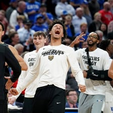 College basketball players celebrating an upset tournament victory